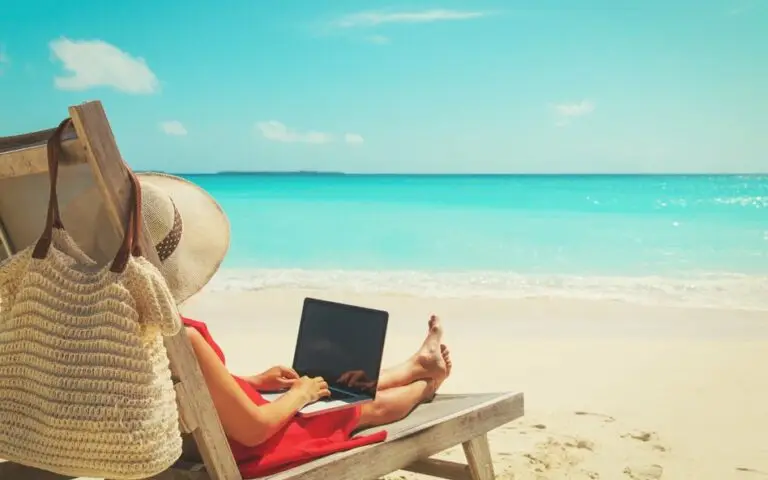 remote work concept young woman with laptop on beach